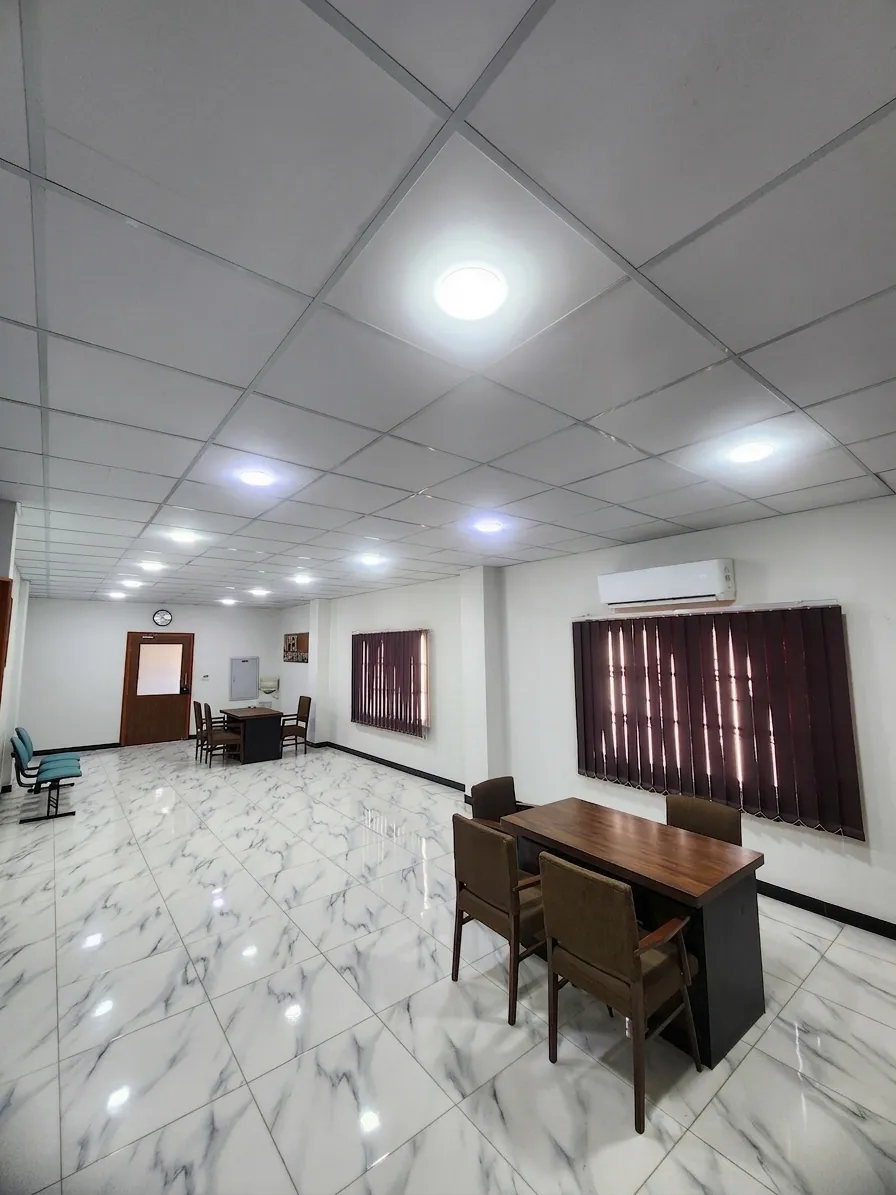 Main office area at Apex Corporation knitwear manufacturer facility in North Karachi Industrial Area Pakistan with conference tables and seating